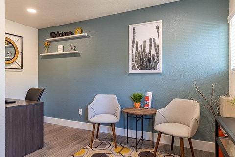 a living room with two chairs and a table